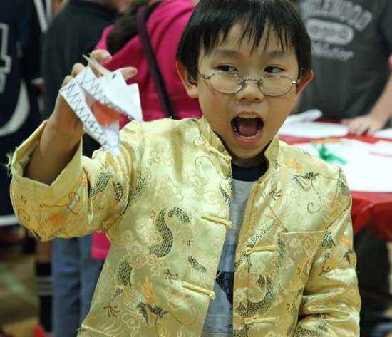 Jeffrey Young plays with an origami dragon. 